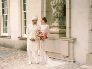 Multi-Cultural couple gazing in each others eyes at the Swan House